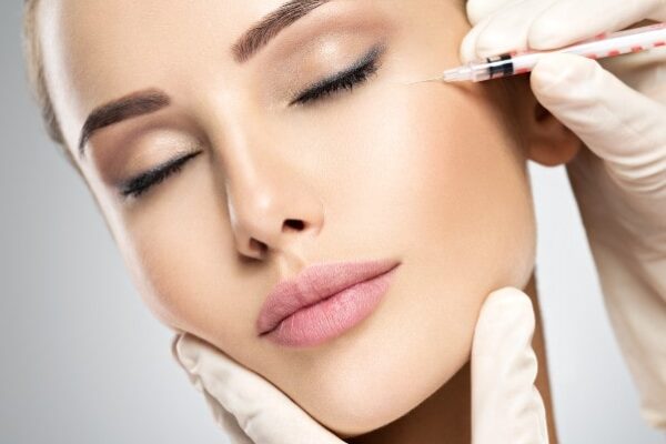 woman-getting-cosmetic-injection-of-botox-near-eye-min